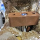Closeup of cable stop. You can just see the orange outer cable running into the brown block at the bottom, and then the inner cable continuing to run up to the FD