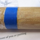 Closeup of tube showing both rough end for epoxy adhesion, and tape/cling film protection of main part of the tube