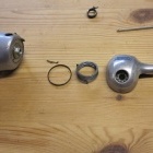 Front coverplate, spring, and seal, seperated from brake lever