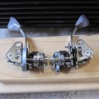 Closeup of both lever mechanisms after cleaning in white spirits - they are sitting in front of a blow fan for drying out before relubing