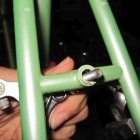 This photo illustrates how much the mounting hole, in the rear brake bridge, was drilled and is now too wide for the brake mounting bolt