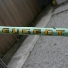 Damage to the downtube paint and decals at the letters G & E of PEUGEOT, also around the gear lever boss